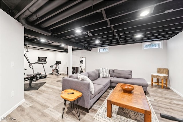 living room featuring a healthy amount of sunlight and light hardwood / wood-style floors