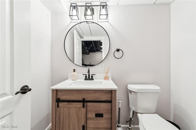 bathroom featuring vanity and toilet