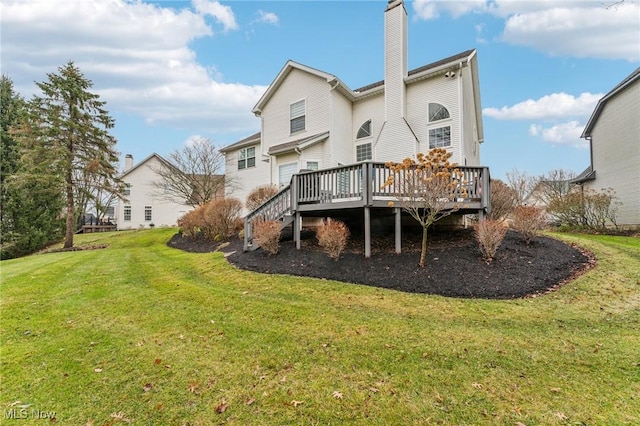 back of house featuring a yard and a deck