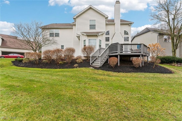 rear view of house with a deck and a lawn