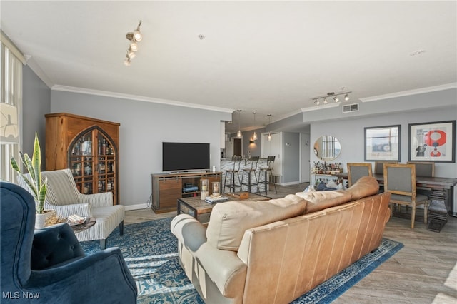 living room featuring light wood-type flooring and ornamental molding