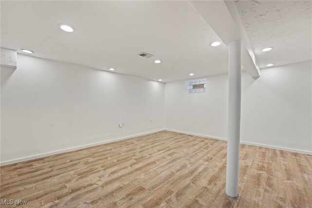 basement featuring light hardwood / wood-style flooring