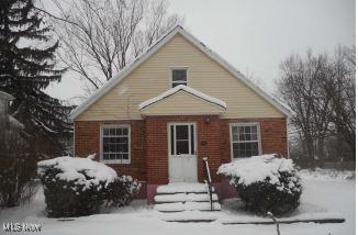 view of snow covered rear of property