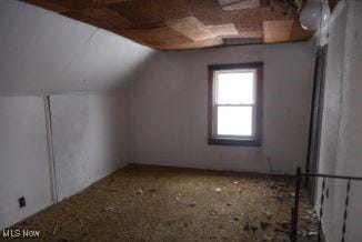 additional living space featuring lofted ceiling