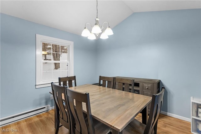 dining room with baseboard heating, light hardwood / wood-style floors, lofted ceiling, and a notable chandelier