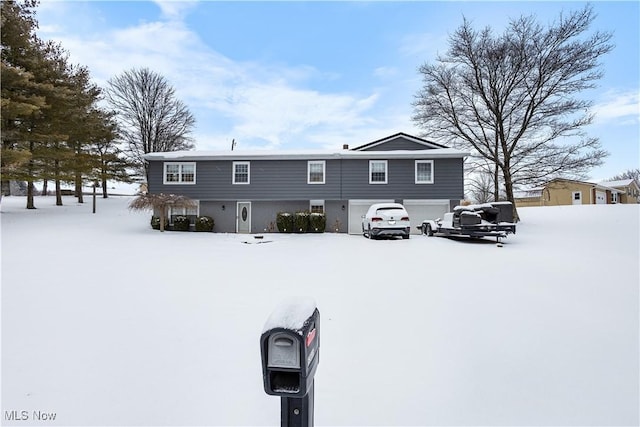 view of snow covered back of property