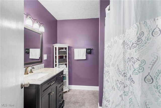 bathroom with vanity and a textured ceiling