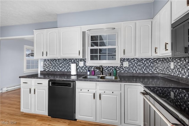 kitchen with decorative backsplash, baseboard heating, sink, black dishwasher, and white cabinetry