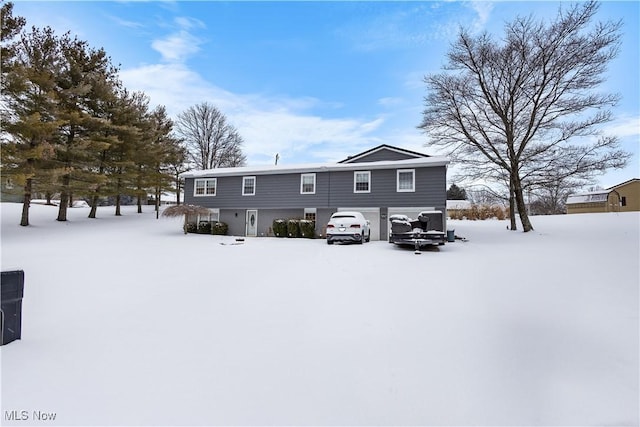 view of snow covered rear of property