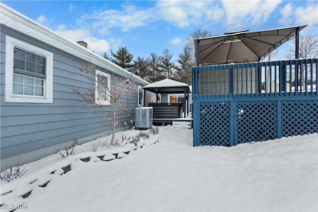 yard covered in snow featuring a gazebo and cooling unit