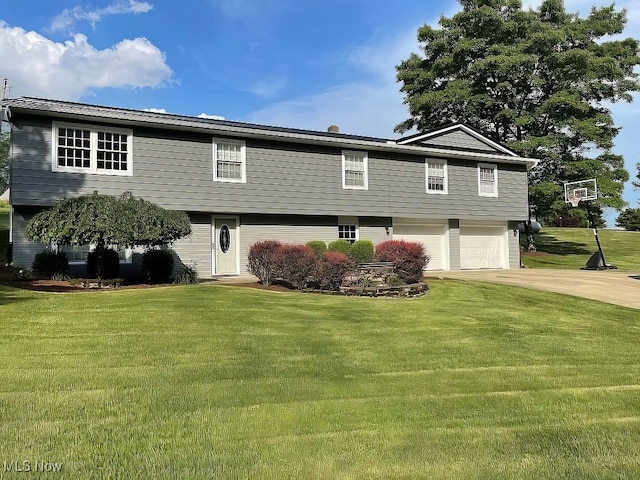 split foyer home with a front lawn and a garage