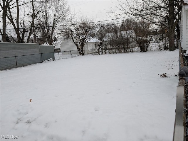 view of yard layered in snow