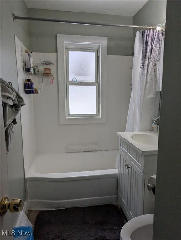 full bathroom featuring shower / bathtub combination with curtain, vanity, and toilet