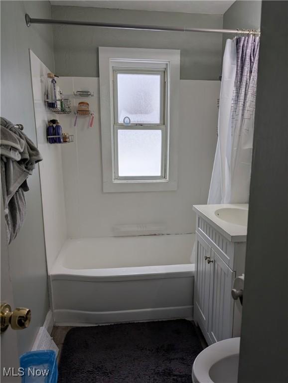 full bathroom with shower / bath combination with curtain, vanity, and toilet