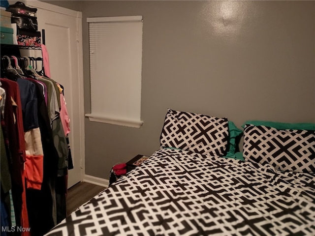 bedroom with dark hardwood / wood-style flooring