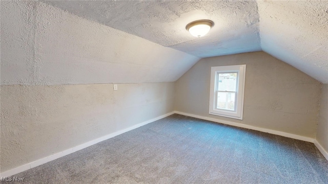 bonus room featuring carpet flooring, a textured ceiling, and lofted ceiling