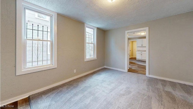 unfurnished bedroom featuring carpet flooring and a textured ceiling