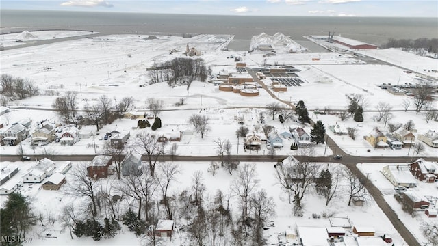 snowy aerial view featuring a water view