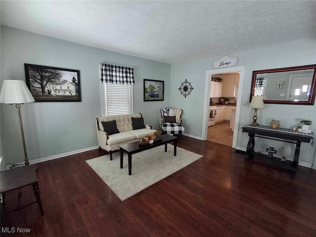 living room with dark wood-type flooring and a textured ceiling