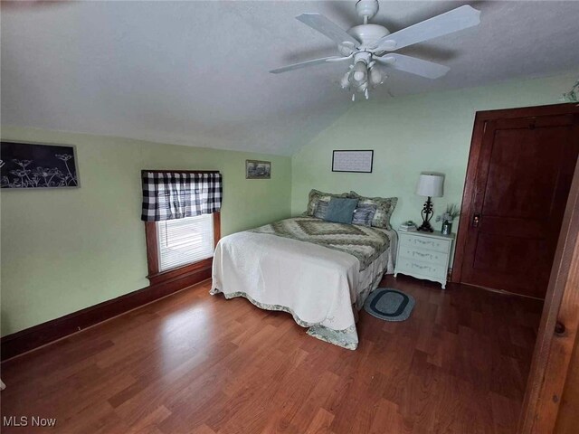 bedroom with dark wood-type flooring, ceiling fan, and lofted ceiling