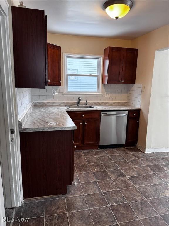 kitchen featuring sink, dark brown cabinetry, stainless steel dishwasher, and tasteful backsplash