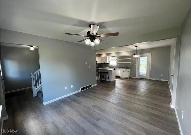 unfurnished living room with hardwood / wood-style floors and ceiling fan