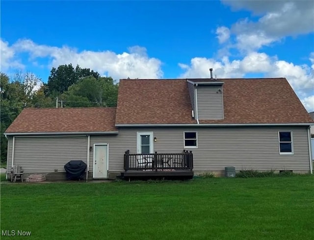 back of property with a yard and a wooden deck