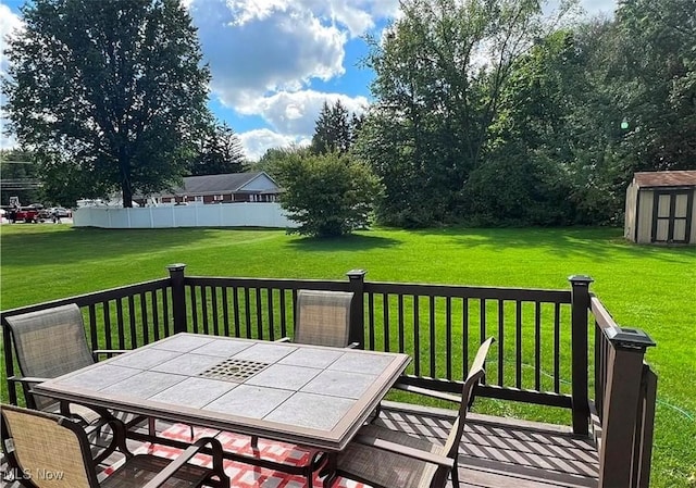 wooden deck featuring a lawn