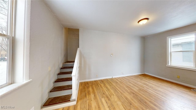 stairway with hardwood / wood-style flooring