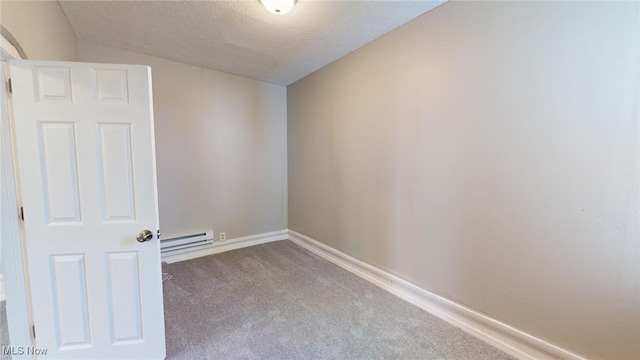 unfurnished room featuring carpet flooring, a baseboard radiator, and a textured ceiling