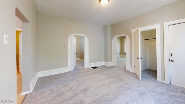 unfurnished bedroom with light carpet