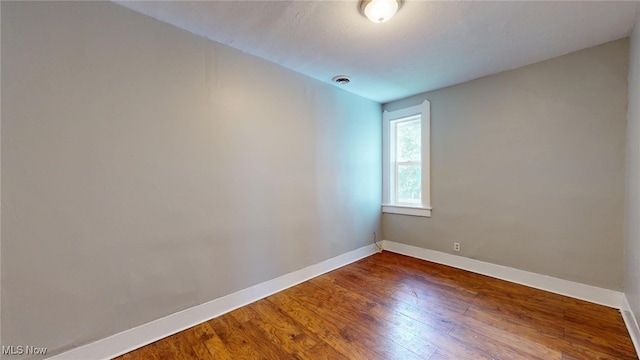 unfurnished room featuring hardwood / wood-style flooring