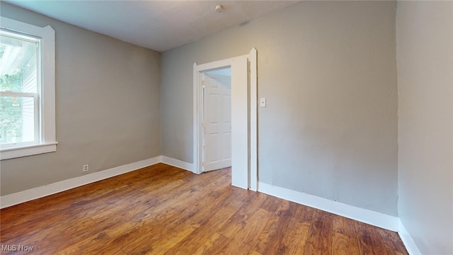 unfurnished room featuring hardwood / wood-style flooring