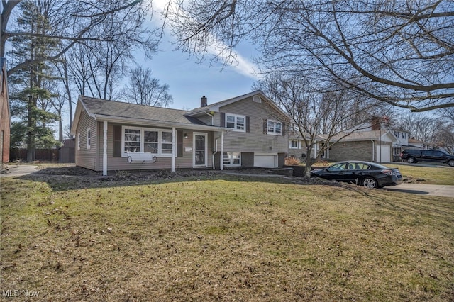 tri-level home with a front yard and a garage