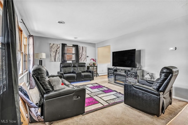 living room featuring a fireplace and a baseboard heating unit