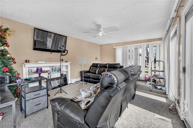 living room with ceiling fan, light colored carpet, and a textured ceiling