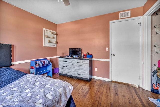 bedroom with ceiling fan and wood-type flooring