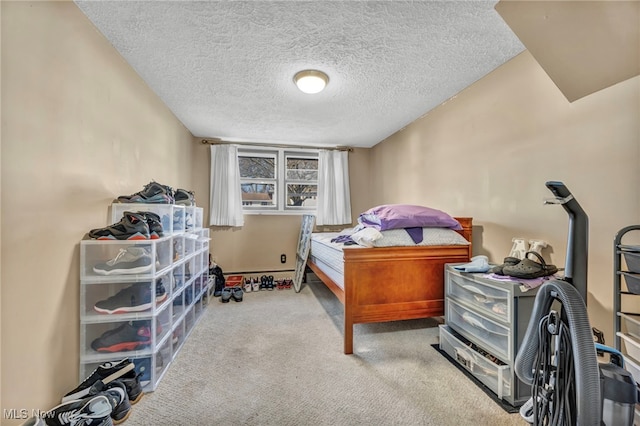 bedroom featuring a textured ceiling and light carpet