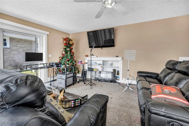 living room with ceiling fan, carpet, and a textured ceiling