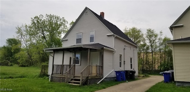 rear view of house with a yard