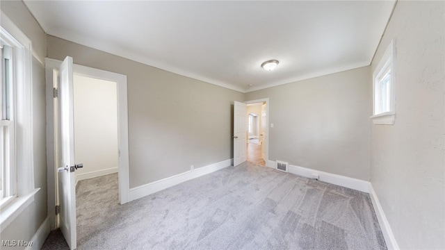 empty room featuring light carpet