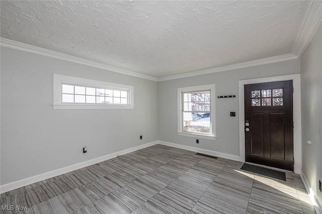 foyer with a textured ceiling and crown molding