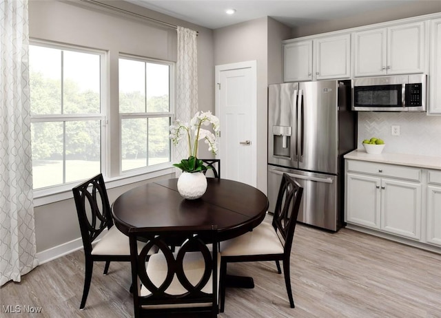 dining space with light hardwood / wood-style flooring