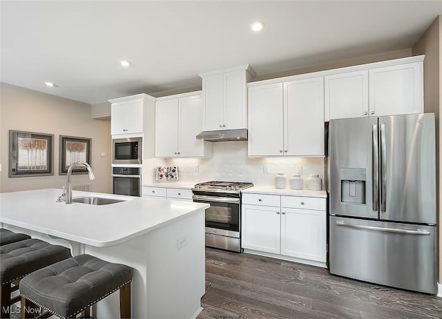 kitchen featuring white cabinets, sink, appliances with stainless steel finishes, and tasteful backsplash