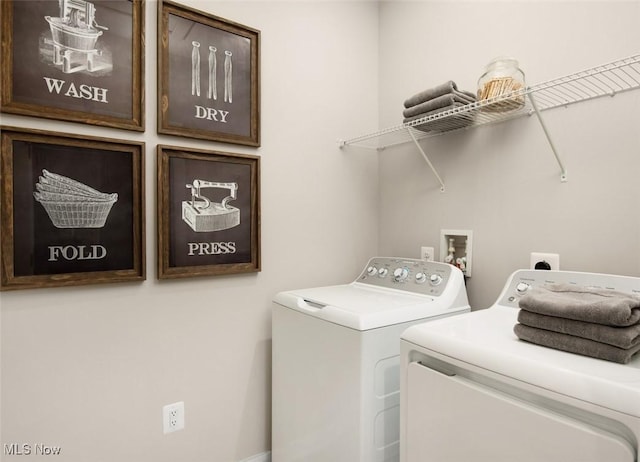 clothes washing area featuring cabinets and independent washer and dryer