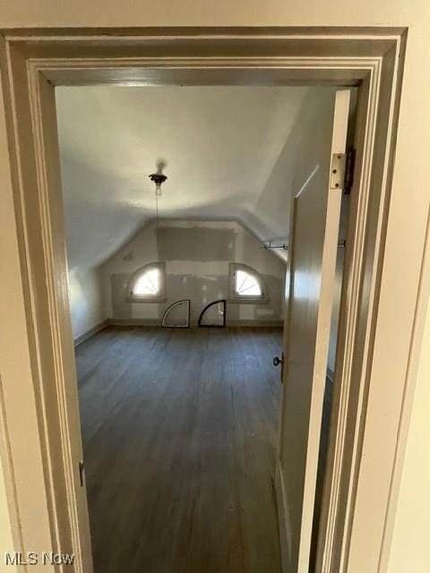 bonus room featuring dark hardwood / wood-style flooring and vaulted ceiling