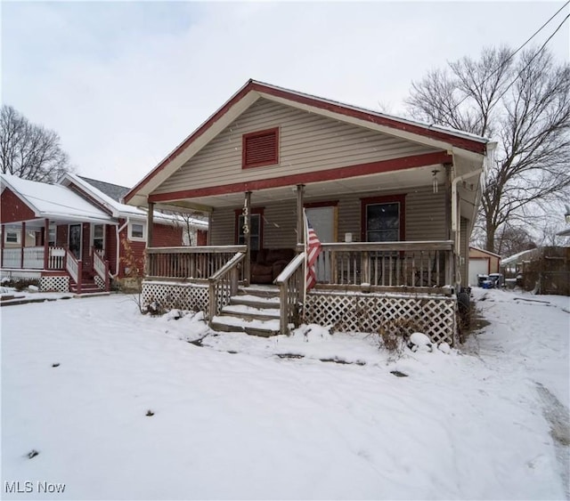 bungalow with a porch and a garage