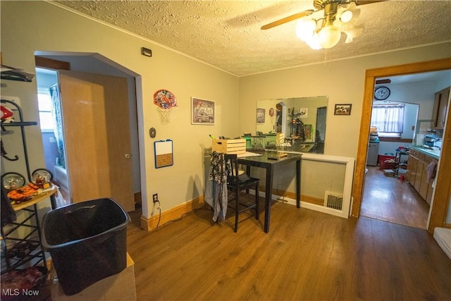 dining area with a wealth of natural light, hardwood / wood-style floors, ceiling fan, and a textured ceiling