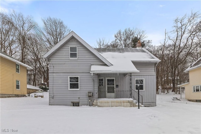 view of snow covered back of property