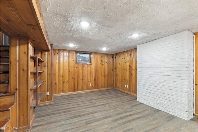 basement featuring hardwood / wood-style floors and a textured ceiling